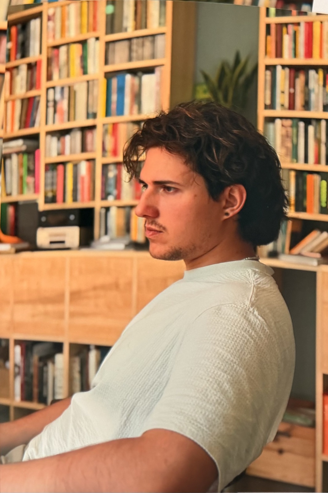 Sitting in a room lined with bookshelves, 2026