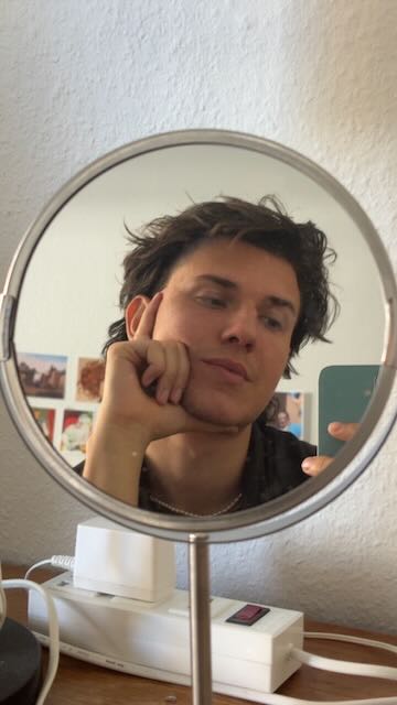 Reflection in a round vanity mirror, September 2025