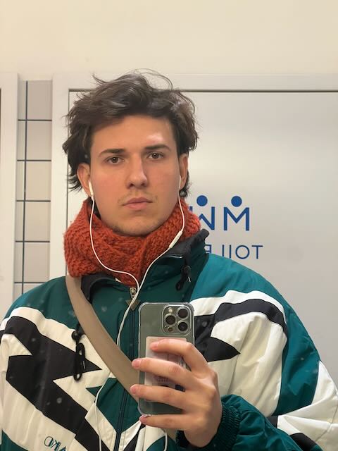 Mirror photo in a vintage ski jacket and orange scarf, Prague, November 2024